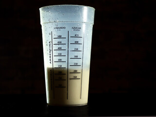 Milk in meter with dark background