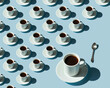 © Janna - Rhythmic pattern from cups with coffee on a blue background.