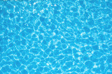 Fototapeta Sypialnia - The water ripples in a blue transparent pool. Waves and ripples in the pool.