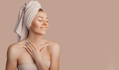 Wall Mural - beautiful sensual young girl with clean skin on a beige background with a mockup. topless woman in a