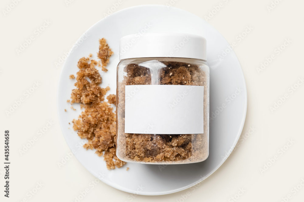 Jar of body scrub on light background