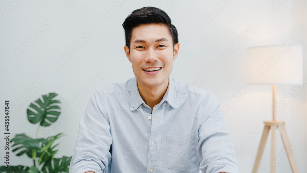 Portrait of successful handsome executive businessman smart casual wear looking at camera and smiling, happy in modern office workplace. Young Asia guy talk to colleague in video call meeting at home. - obrazy, fototapety, plakaty 