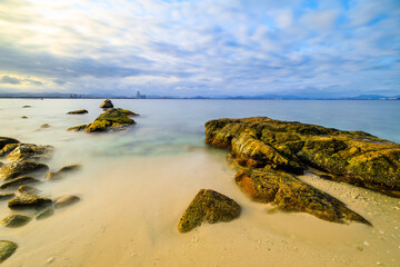 Landscape with beach,the sea and the beautiful clouds in the blue sky.rocks on the beach.