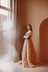 beautiful woman model posing in elegant dress in the studio