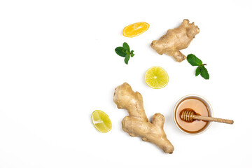 Ginger root, honey, lemons slices and green fresh mint flat lay isolated on white background. Food balance and detox concept composition.