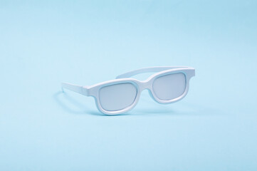 Levitating white glasses on blue background. 3D photo. Minimalistic still life. Creative layout. Concept art