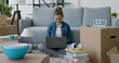 © StockPhotoPro - Woman moving in her new home and connecting with her laptop