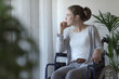 © StockPhotoPro - Sad woman in wheelchair looking outside