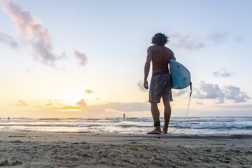 Sticker - Young caucasian man get up early to  doing surf at sunrise