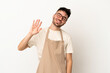 Restaurant waiter caucasian man isolated on white background saluting with hand with happy expression