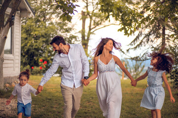 Wall Mural - Happy family playing in backyard.