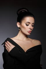 classic beauty portrait of woman with perfect evening makeup on dark background. perfect skin withou
