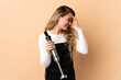 © luismolinero - Young brazilian woman using hand blender isolated on beige background laughing
