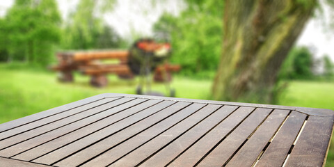 Wooden desk of free space and grill background 