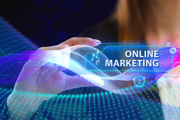 Business, Technology, Internet and network concept. Young businessman working on a virtual screen of the future and sees the inscription: Online marketing