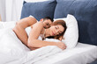 © LIGHTFIELD STUDIOS - Pretty woman sleeping near boyfriend at home