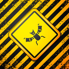 Sticker - Black Flying bat icon isolated on yellow background. Happy Halloween party. Warning sign. Vector