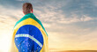 Brazilian man with Brazilian flag looking at the horizon