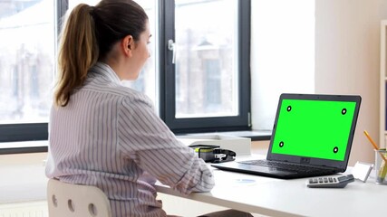 Poster - remote job, technology and people concept - happy smiling young woman with green screen on laptop computer having video call at home office