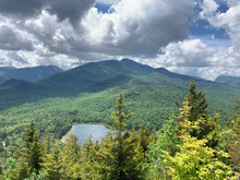Clouds Over High Peaks Of The Adirondack Mountains And Heart Lake Near Lake Placid, New York State