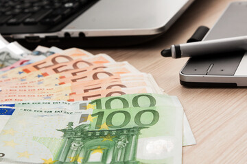 Close-up of euro on laptop background. Euro banknotes