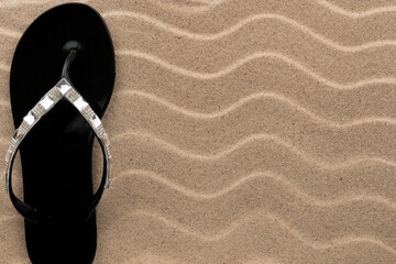 Sticker - Sandy beach background with flip flops. Summer concept.