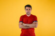 © Davidbenito - Soccer fan in red jersey poses with crossed arms