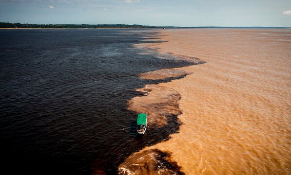 aerial image of the meeting of the rio negro and solimões waters in the amazon manaus brazil
