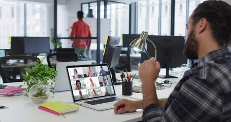 Wall Mural - Middle eastern man having a video conference with colleagues on laptop at office