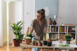 © cherryandbees - woman gardening houseplants at home