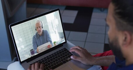 Sticker - Middle eastern man having a video call with senior male office colleague on laptop