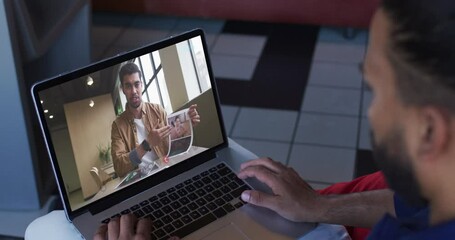 Poster - Middle eastern man having a video call with male office colleague on laptop