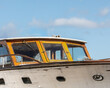 An old deteriorating wooden cabin cruiser bridge windows