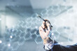 © Pixels Hunter - Double exposure of male hand with pen working with abstract virtual technology hologram with hexagon on blurred office background. Research and development software concept