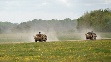 2 British army Supacat Jackal MWMIK rapid assault, fire support and reconnaissance vehicles on maneuvers in a demonstration of firepower, Salisbury Plain military training area