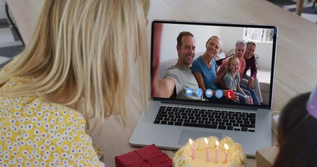 Poster - Caucasian mother and daughter sitting at table using laptop having birthday video call