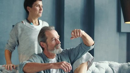 Wall Mural - an aged couple sitting on the couch and talking about it