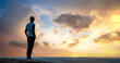 © bilanol - Silhouette of a woman hiker standing alone enjoying sunset outdoors. Female tourist on rural field in evening nature. Tourism, traveling and healthy lifestyle concept.