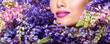 © Svetlana Fedoseeva - Beautiful woman face surrounded by violet flowers. Spring Flower. Springtime. Professional makeup,