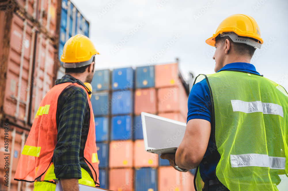 logistic worker teamwork and partner of foreman, engineer, and businessman working in an international shipping area, concept of business industrial and working in container yard to import and export - obrazy, fototapety, plakaty 