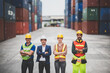 © chokniti - logistic worker teamwork and partner of foreman, engineer, and businessman working in an international shipping area, concept of business industrial and working in container yard to import and export