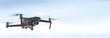 small drone with high resolution camera hovering in air for aerial photography