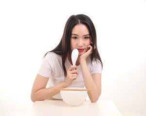 Wall Mural - Beautiful young south east Asian woman holding chinese empty chopstick soup spoon bowl utensil pretend acting posing see eat taste feed offer satisfaction yummy white background happy