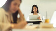 © bongkarn - Female student using tablet while sitting in the back ​side in classroom