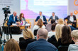 © Anton Gvozdikov - Speakers discussing business problems in auditorium