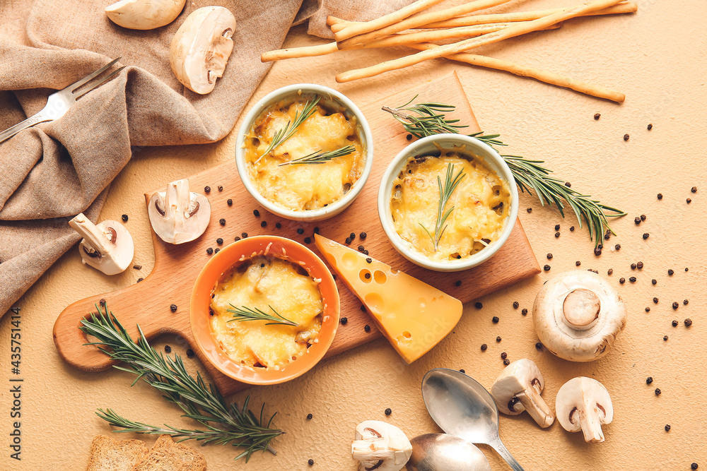 Ramekins with tasty julienne and ingredients on color background