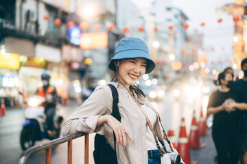 Wall Mural - Young adult asian woman traveller backpack traveling in city lifestyle chinatown street food  with bokeh background.