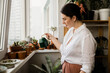 © Beznika - woman watering succulent plants on the balcony from a watering can