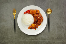 Homemade Massaman Chicken With Chili Paste, Coconut Milk , Steamed Rice On A White Plate