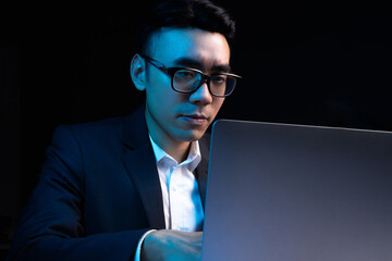 Portrait of Asian male programmer working at night